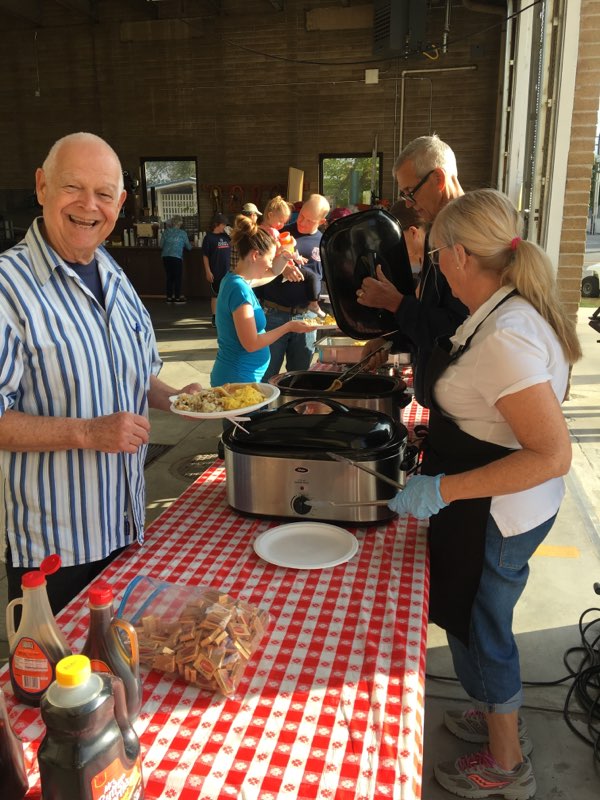 Volunteers serving pancakes and breakfast at the Red, White and Breakfast fundraiser